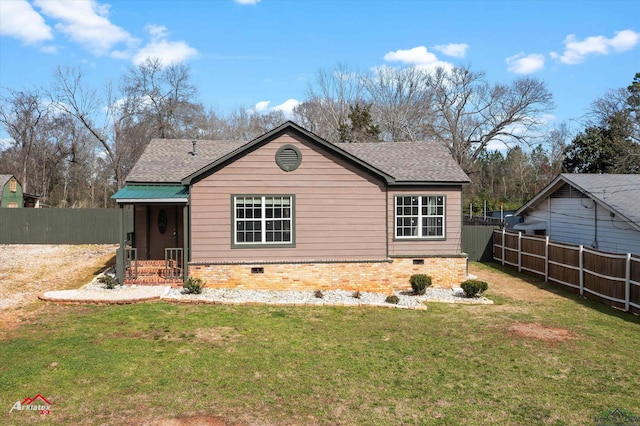 exterior space featuring crawl space, fence, a front lawn, and roof with shingles