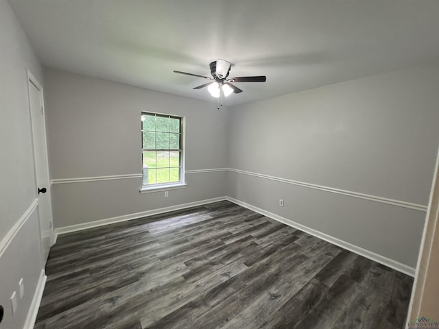 spare room with dark wood-style floors, ceiling fan, and baseboards