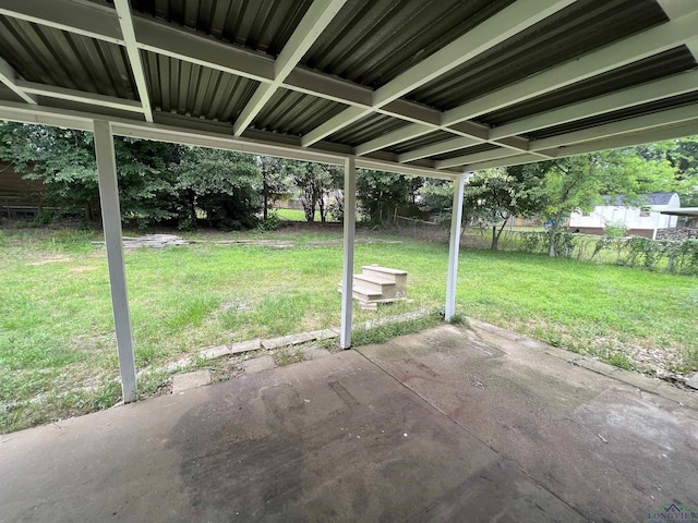 view of patio with a carport and fence