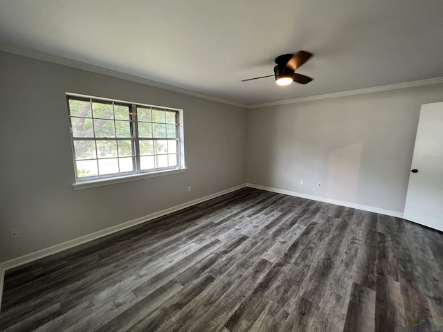 empty room featuring ornamental molding, baseboards, and dark wood-style floors