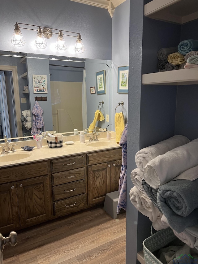 bathroom with hardwood / wood-style floors, vanity, and curtained shower