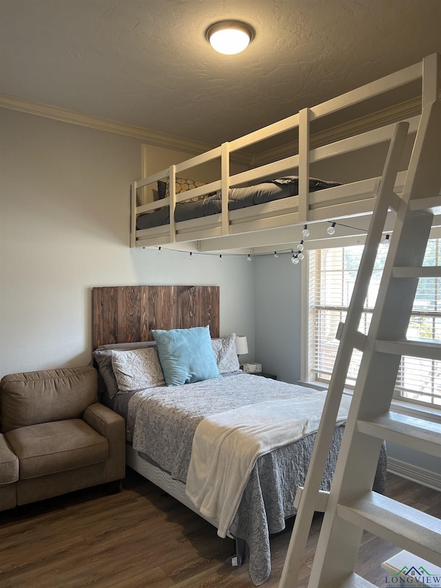 bedroom with hardwood / wood-style flooring and ornamental molding