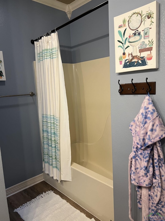 bathroom featuring hardwood / wood-style flooring, shower / bath combo, and ornamental molding