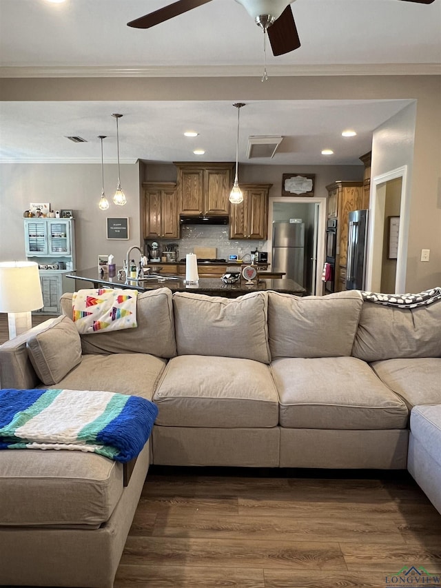 living room with dark hardwood / wood-style floors and crown molding