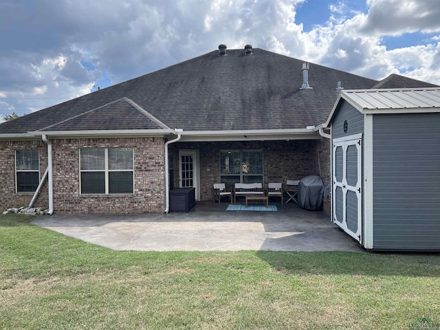 rear view of house featuring a patio area and a yard