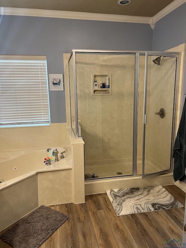 bathroom featuring hardwood / wood-style flooring, ornamental molding, and plus walk in shower