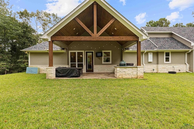 rear view of house featuring a lawn and a patio area