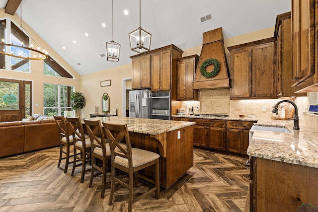 kitchen with a center island, high vaulted ceiling, sink, custom range hood, and stainless steel appliances