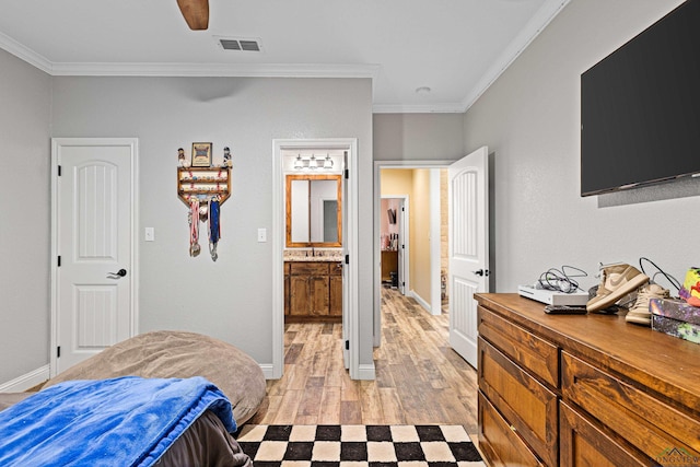 bedroom featuring connected bathroom, crown molding, ceiling fan, and light wood-type flooring