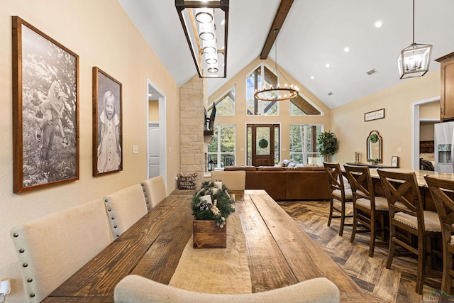 dining room with parquet flooring, beam ceiling, a chandelier, and high vaulted ceiling