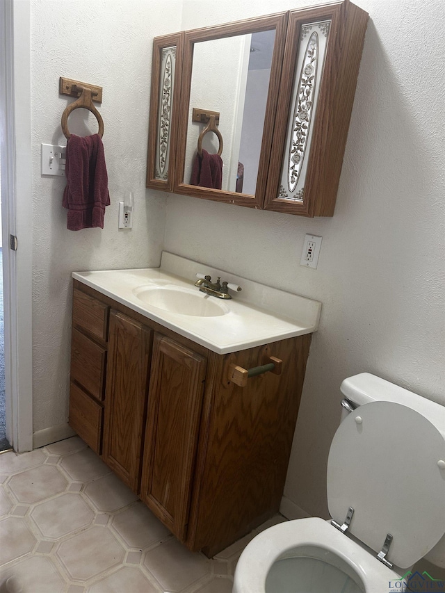 bathroom featuring toilet and vanity