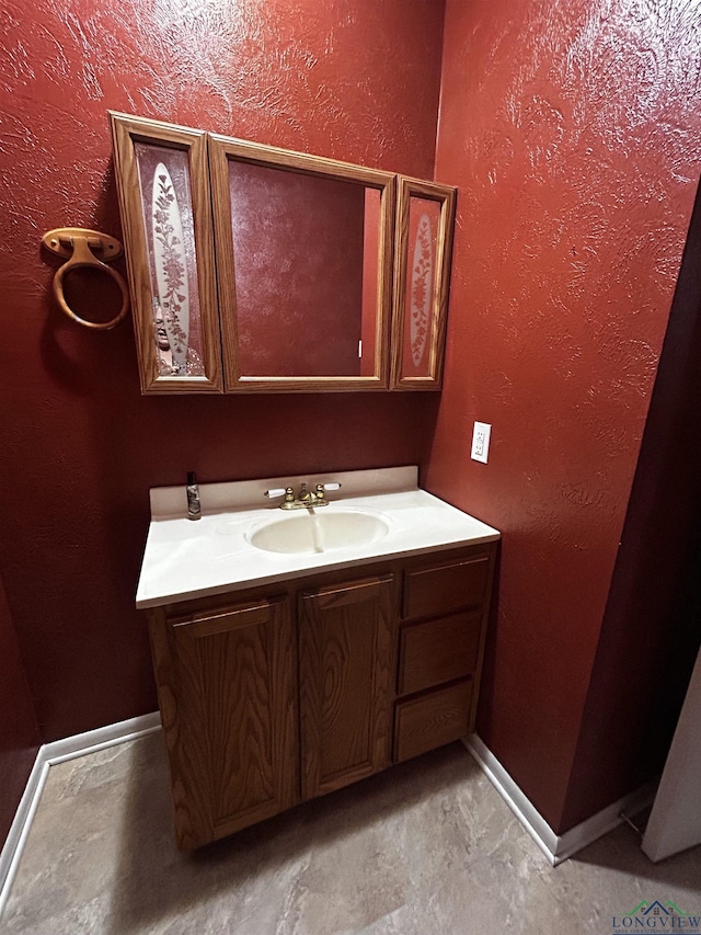 bathroom featuring vanity and baseboards