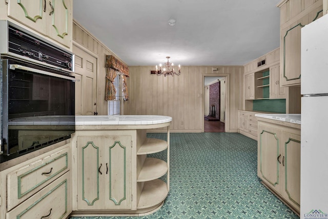 15 Covington Dr, Longview, TX 75602 - kitchen with open shelves, oven, a chandelier, a peninsula, and tile countertops
