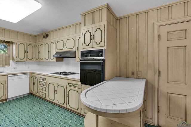 15 Covington Dr, Longview, TX 75602 - kitchen featuring dishwasher, oven, tile countertops, under cabinet range hood, and tasteful backsplash