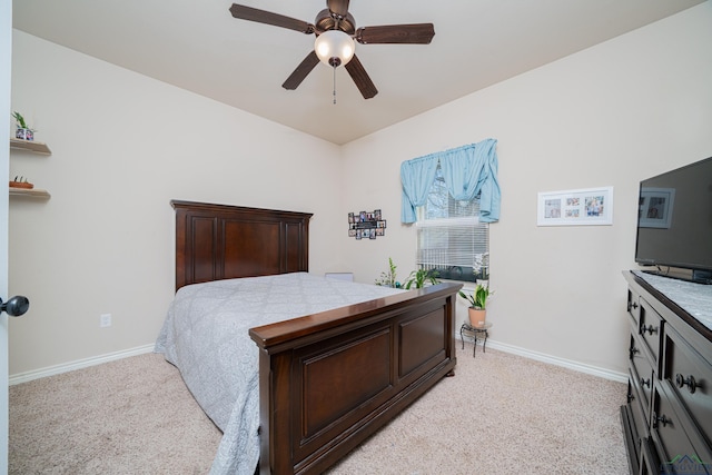 bedroom featuring light colored carpet, ceiling fan, and baseboards