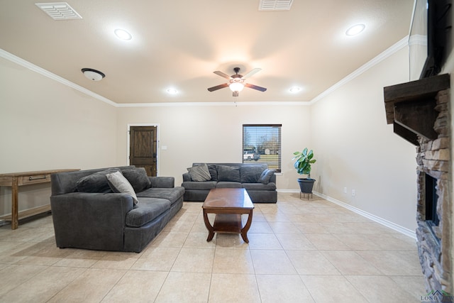 living area featuring light tile patterned floors, visible vents, ornamental molding, and a stone fireplace