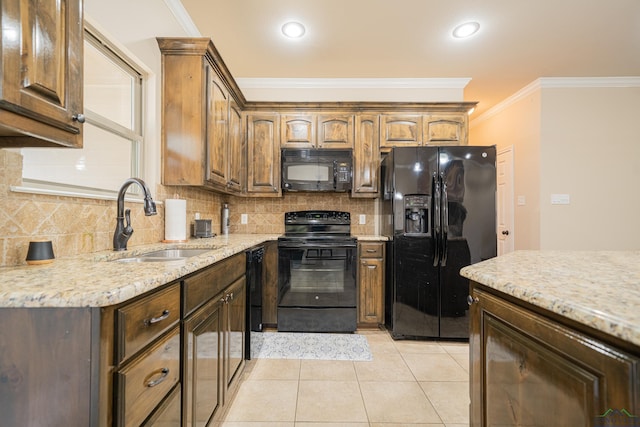 kitchen with light tile patterned floors, tasteful backsplash, ornamental molding, black appliances, and a sink