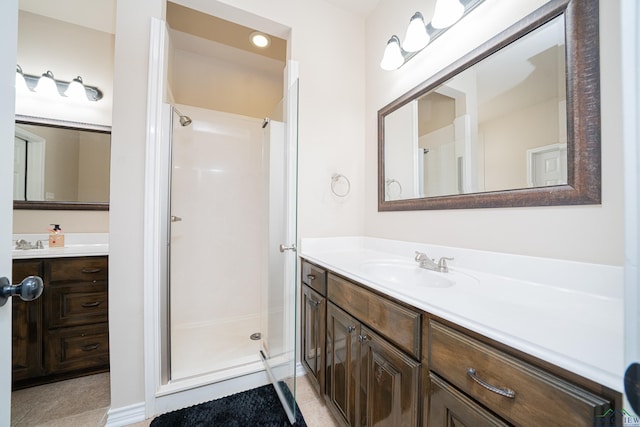 bathroom featuring a stall shower, tile patterned flooring, and vanity