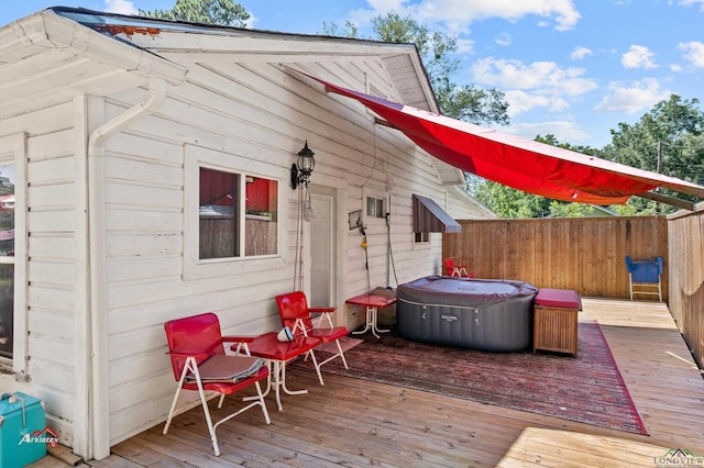 wooden deck with a hot tub