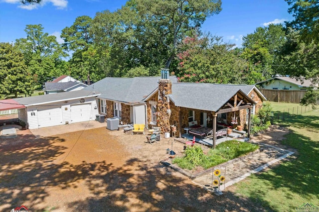 view of front of home with cooling unit and a garage