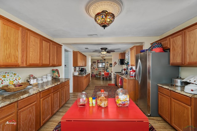 kitchen with ceiling fan, light wood-type flooring, and appliances with stainless steel finishes