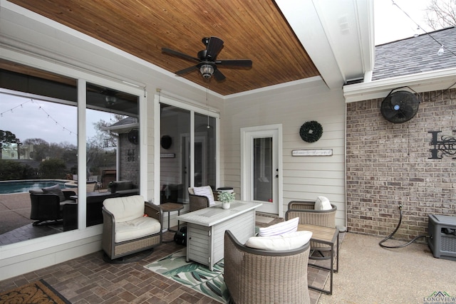 view of patio / terrace featuring ceiling fan and a fenced in pool