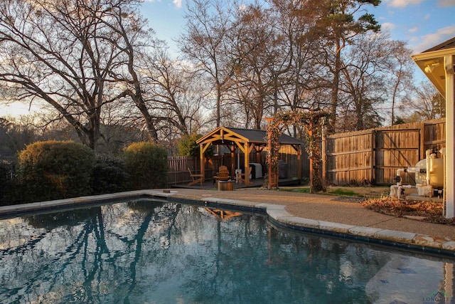 view of swimming pool featuring a gazebo and a patio area