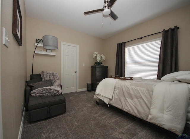 bedroom with ceiling fan and dark carpet