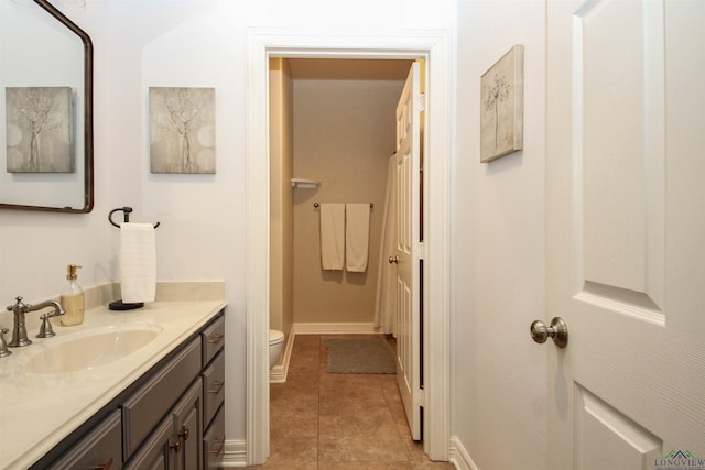 bathroom featuring tile patterned floors, vanity, and toilet