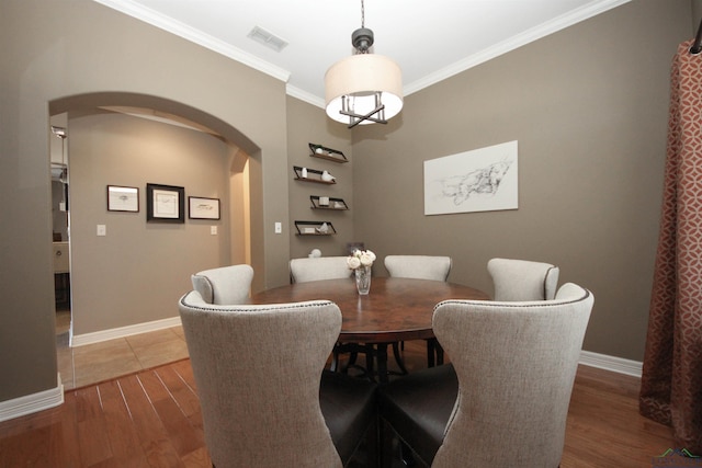 dining space with crown molding and dark hardwood / wood-style floors