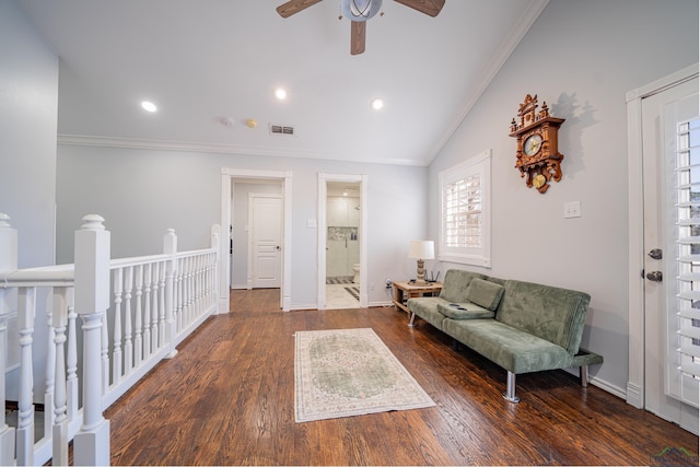 living area featuring visible vents, vaulted ceiling, wood finished floors, and ornamental molding