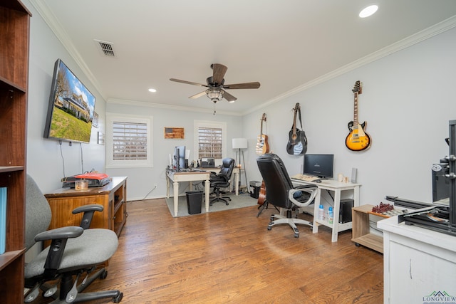 home office featuring visible vents, ornamental molding, and wood finished floors