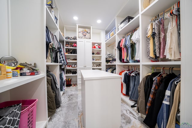 walk in closet featuring marble finish floor