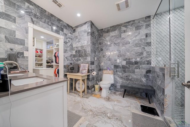 full bath featuring toilet, a stall shower, visible vents, and tile walls