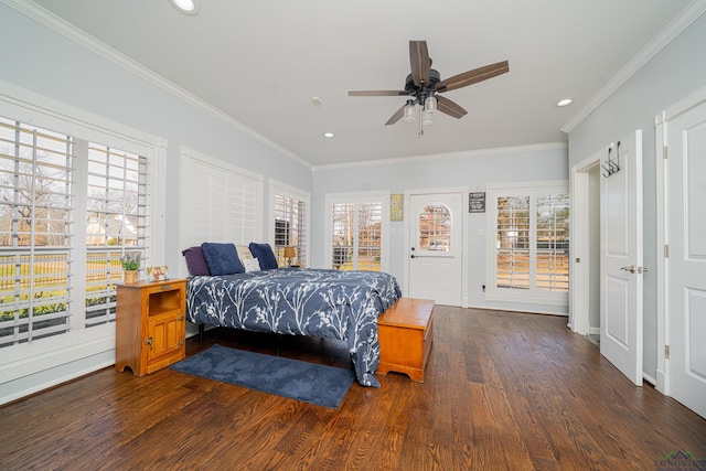 bedroom with crown molding, multiple windows, and wood finished floors