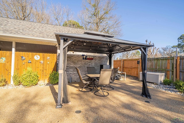 view of patio / terrace featuring fence, outdoor dining area, and a gazebo