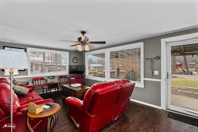 living room featuring ceiling fan and dark hardwood / wood-style flooring