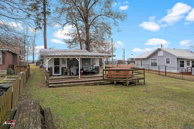 back of house with a wooden deck and a yard