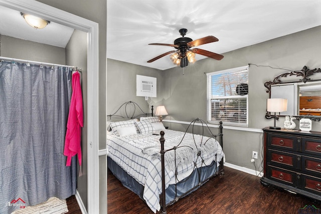 bedroom with dark hardwood / wood-style flooring, an AC wall unit, and ceiling fan