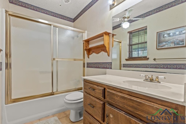 full bathroom with ceiling fan, tile patterned flooring, enclosed tub / shower combo, a textured ceiling, and toilet