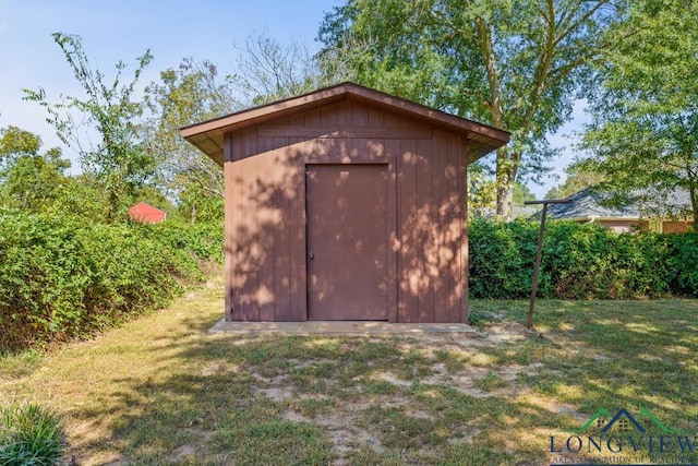 view of outbuilding featuring a yard