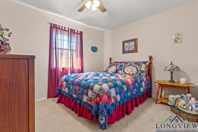 bedroom with ceiling fan, light carpet, and a textured ceiling