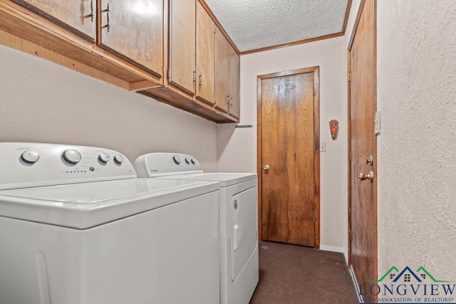 washroom featuring dark carpet, cabinets, crown molding, washing machine and dryer, and a textured ceiling