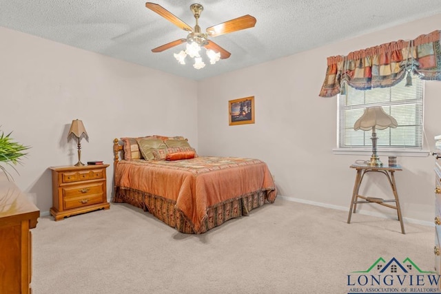 carpeted bedroom featuring a textured ceiling and ceiling fan