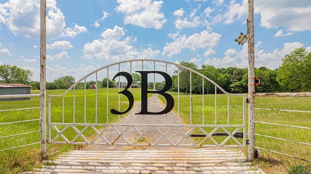 view of gate featuring a lawn