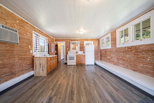kitchen with a sink, white appliances, light countertops, dark wood finished floors, and a wall mounted AC