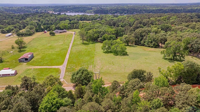 birds eye view of property featuring a rural view and a wooded view