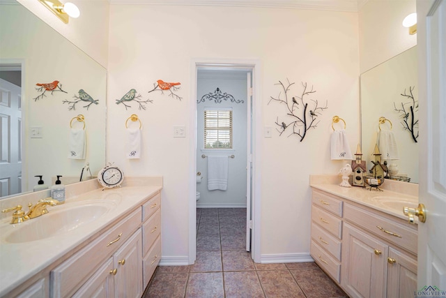 full bath with tile patterned flooring, a sink, baseboards, and two vanities