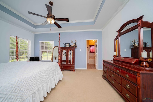 bedroom featuring crown molding, baseboards, a tray ceiling, and light carpet