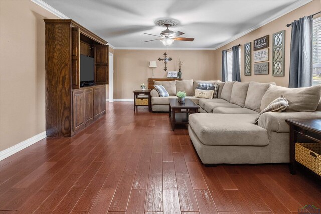 living room with ornamental molding, dark wood-type flooring, ceiling fan, and a healthy amount of sunlight